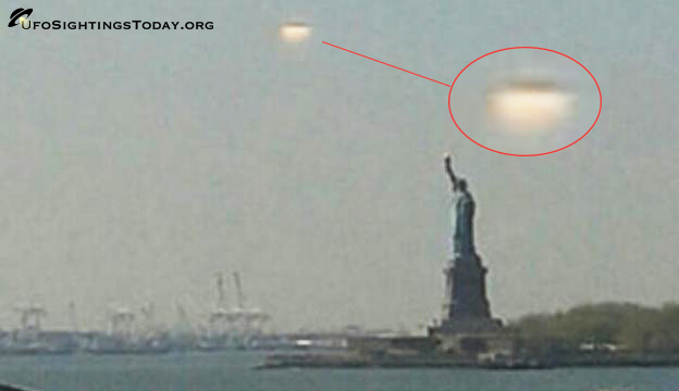 giant ufo hovers over statue of libery
